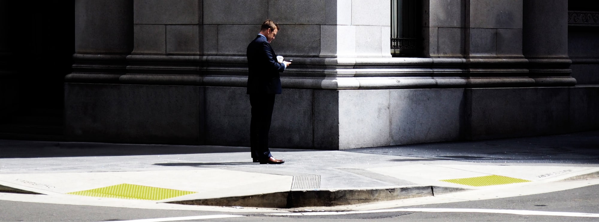 Business man standing outside bank