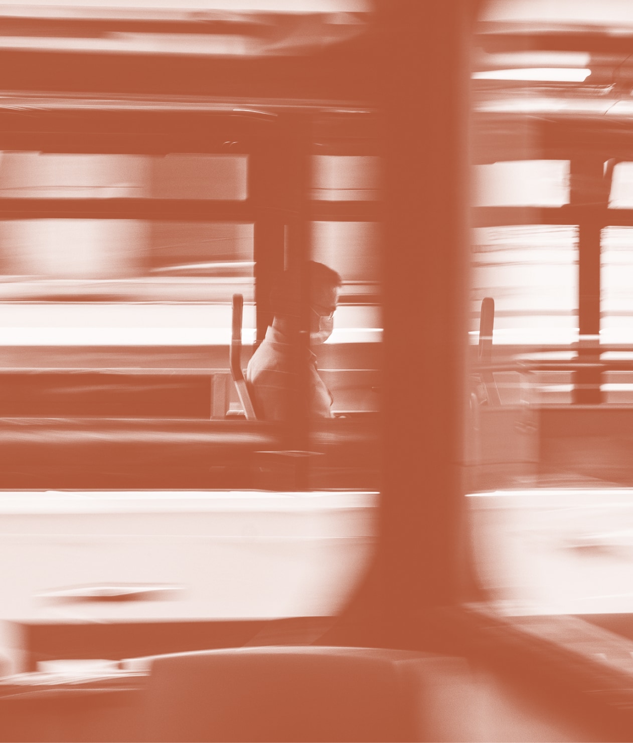 Man sitting on bus wearing mask