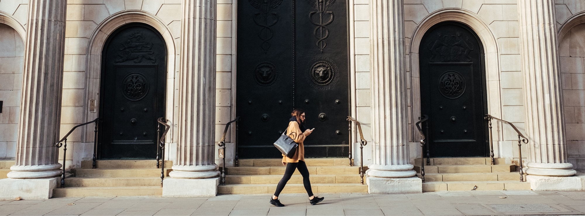 Woman walking in front of bank