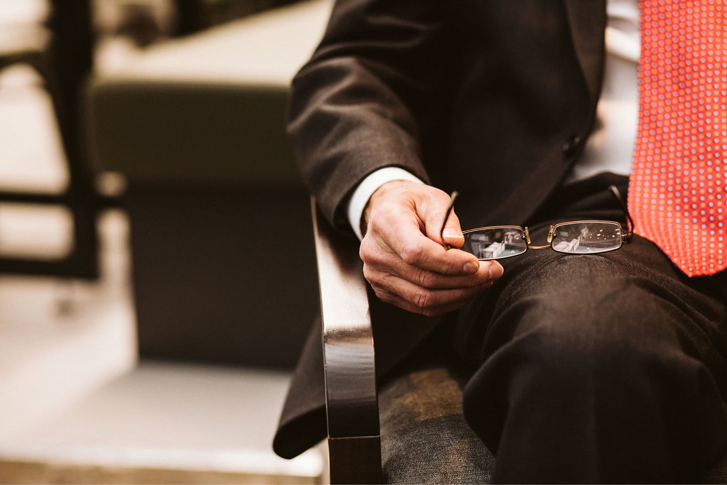 Close up of Andrew holding glasses