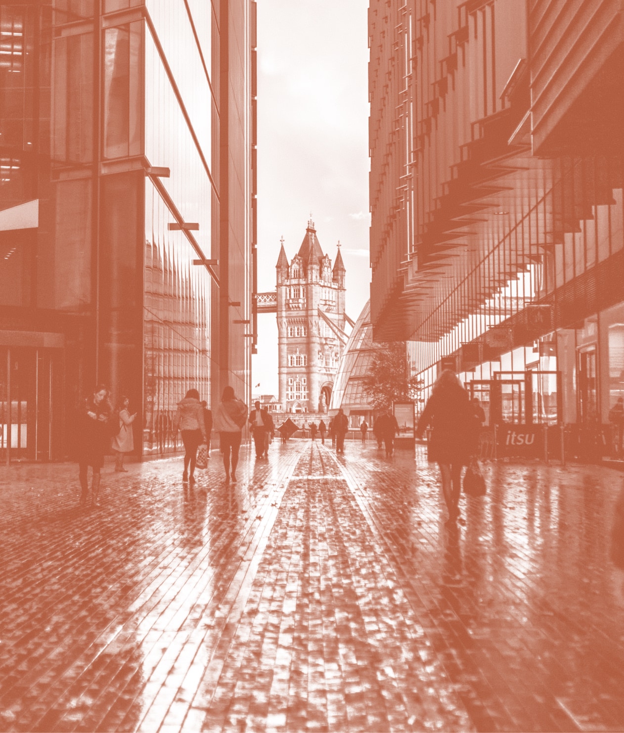 People walking through alleyway towards Tower Bridge